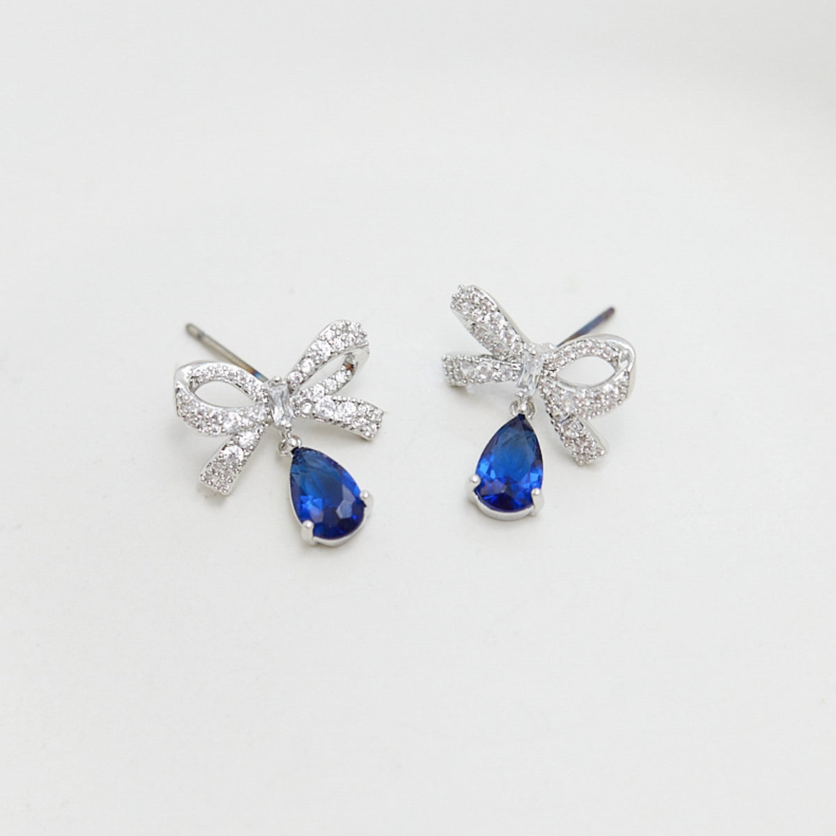 Jon Richard Rhodium Plated Cubic Zirconia Bow And Blue Peardrop Earrings